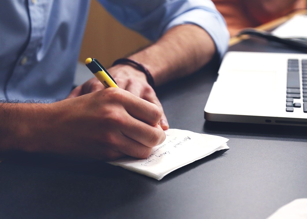 Close up of a hand writing a letter